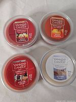 Top view of four Yankee Candle Scenterpiece Easy MeltCups showing fragrances and wax colors