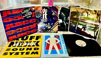 Front view of seven 12" singles showing sleeve artwork