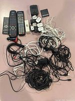 Overall view of remotes, adapters and tangled cables