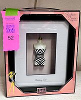 Retail box front showing framed bathing suit display