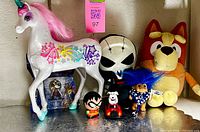 Group shot of all seven toys together on shelf