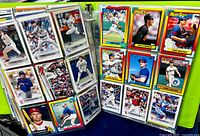 Open binder showing two filled pages of Topps and other brand baseball cards