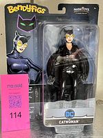 Front view of packaged Catwoman Bendyfigs figure showing entire blister card and MaxSold lot card