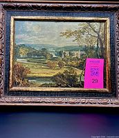 Front view of framed landscape print with carved frame