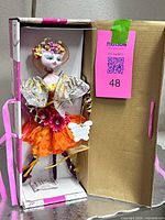 Figurine inside original pink and white box showing full costume and accessories