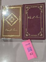 Front covers of both leather-bound books, one wrapped, one unwrapped