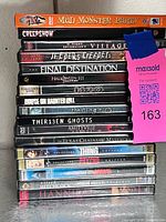 Stacked side view of DVD lot showing most spines