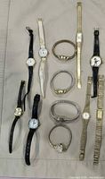 All 12 watches laid out on fabric background
