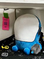 Front view of blue and white Carbot Marine plush with tag visible