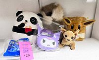 Group shot showing all seven plush and toy items on shelf