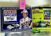 Front view of Goulds Pumps patch display, Jeff Gordon ProTalk blister pack, loose green Mustang II diecast