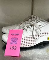 Side view of both sneakers showing perforated upper and Ferrari badge