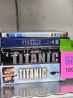 Stack showing spine labels of VHS and DVD editions