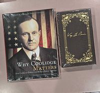 Front view of both sealed books side by side