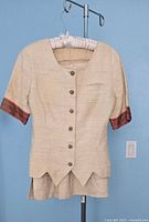 Front view of blazer and skirt set on hanger