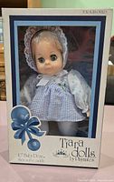 Front of boxed Tiara Baby Dear doll showing full package