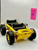 Front three-quarter view of yellow Tonka Jeepster Twister showing body, tires, roll bars, and overall appearance