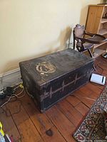 Full view of antique wooden chest positioned on floor