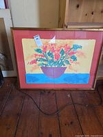 Framed abstract flower planter print on floor