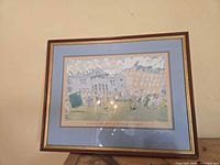 Framed golf print with blue mat and wood frame