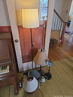 Group of five lamps including floor lamp and four table lamps on floor