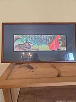 Full view of framed Little Red Riding Hood artwork on table