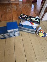 Stacks of blue drawer organizers, tray of thread spools, basket with notions
