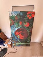 Front view of the Tom Roach tomatoes painting leaning against wall