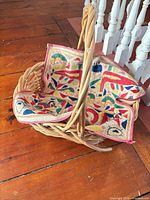Wicker basket with multicolour cloth draped inside