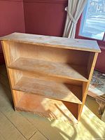 Front view of solid pine bookcase with three shelves