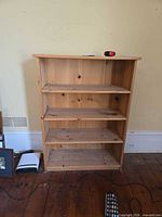 Front view of pine bookcase showing four shelves