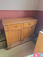 Front view showing drawers, doors, fluted stiles