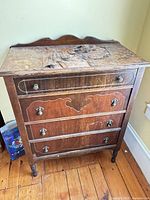 Front view showing four drawers and hardware