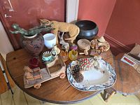 All items laid out on round table showing variety of wooden, ceramic, glass and porcelain pieces