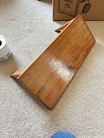 Full view of wooden shelf laying on carpet