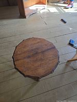 Top view of octagonal wooden table showing scalloped edge and wood grain