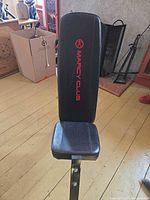 Front view of Marcy Club workout bench showing logo on backrest and seat upholstery
