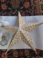 Top view showing paper star, part of vase, one oil lamp