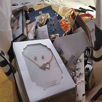 Boxed heart pendant necklace set plus assorted jewelry cards visible