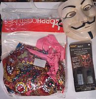 Packaged hippie costume, Guy Fawkes mask, Spirit gum kit