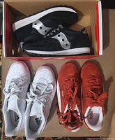 All three pairs of sneakers in box