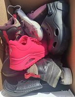 Top view of box showing assorted shoes
