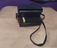 Front angled view showing OneStep 600 label, rainbow stripe and strap