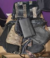 Group view of all bags and wallet piled together