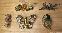 Five brooches laid out showing full lot