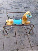 Side view showing full horse and metal frame with springs