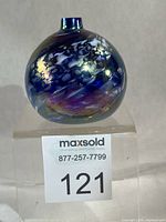 Front view of spherical iridescent glass oil lamp
