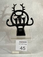 Full front view of metal ceremonial standard on clear riser