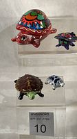 Group shot of all four turtle items on acrylic riser