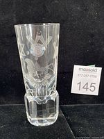 Front view of crystal firing glass with etched Masonic symbols and foil label